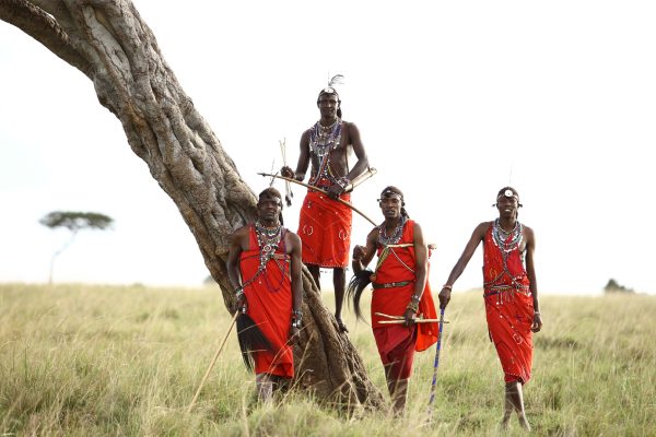 maasai-men-standing-by-a-tree-in-the-masai-mara